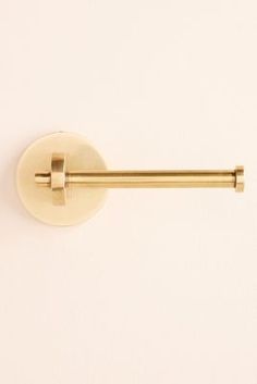 a gold door handle on a white wall