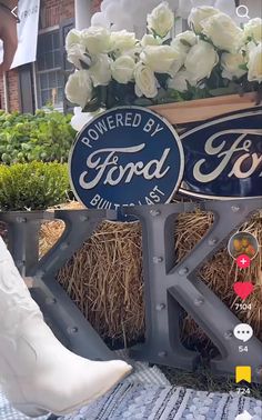 the bride and groom are standing next to each other in front of two ford signs