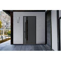 an open door leading into a white building with trees in the backgrouds