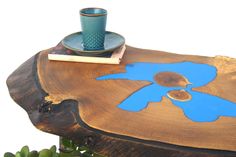 a wooden table topped with a cup and saucer