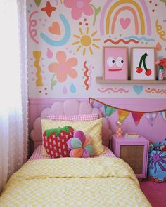 a child's bedroom decorated in pink, yellow and green