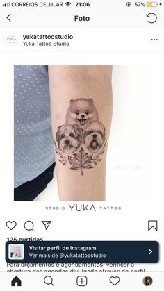 a small tattoo on the arm of a woman with two dogs and leaves in it