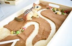 a close up of a cake in the shape of a number with animals on it