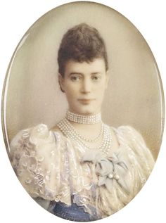 an old photo of a woman wearing pearls