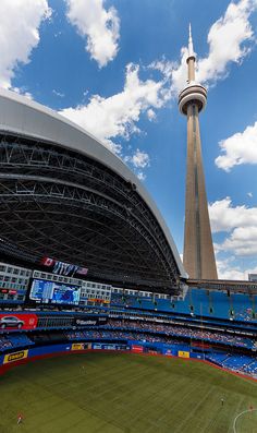 a stadium with a tall tower in the background