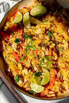 a pan filled with rice and vegetables on top of a table