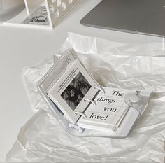 an open book sitting on top of a white table