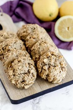 lemon and oatmeal cookies on a cutting board next to sliced lemons