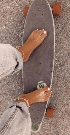 a person standing on top of a skateboard with their feet propped against the board