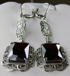 Red Garnet Cubic Zirconia (CZ) Earrings Festoon Design#E8 (long version) Custom Made These are Victorian reproduction estate earrings in sterling silver set with stunning red garnet cubic zirconia gemstones. Each festoon earring is 23mm x 13mm in dimension. The earrings are 2 inches long. The earrings closures are choice of ear wires, deco posts, or lever-backs. Most popular for this earring are the posts and the lever-back style for comfortable wear, and to prevent loss. These lovely earrings w Ornate Red Dangle Earrings, Elegant Garnet Earrings, Red Filigree Dangle Earrings, Elegant Pierced Garnet Earrings, Ornate Red Earrings For Party, Red Sterling Silver Evening Earrings, Red Sterling Silver Earrings For Evening, Elegant Ruby Earrings Nickel-free, Elegant Ruby Earrings Nickel Free