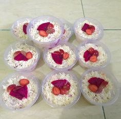 six plastic containers filled with food on top of a tiled floor next to a tile floor