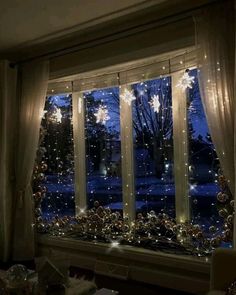 a living room filled with lots of windows covered in christmas lights