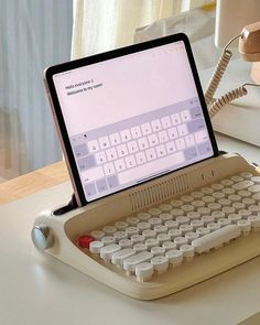 an old typewriter sitting on top of a desk next to a phone and lamp