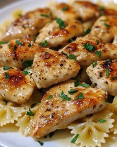 some chicken and pasta on a white plate