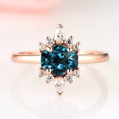 Gorgeous Vintage Inspired Hexagon London Blue Topaz Ring►Made of solid 925 sterling silver with 14K rose gold vermeil finish ►Average band width: 1.6 mmCenter Stone: TopazColor: London BlueShape: HexagonGem size: 6.0 x 7.0 mmCarat Weight: 1.2 ct. (approx.) Gemstone creation: SimulatedHardness: 8.5Accented with simulated diamonds (CZ)►Please be aware that rose gold plating will naturally fade with wear, if this is a concern we would suggest going with the sterling silver or solid gold jewelry opt Topaz Engagement Rings, Drip Drop, Popular Engagement Rings, Topaz Engagement Ring, London Blue Topaz Ring, Topaz Color, Wedding Ring Designs, Creating Jewelry, November Birthstone