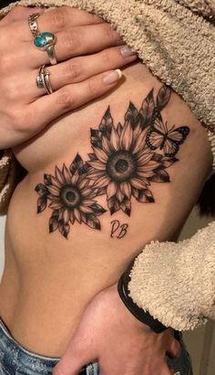 a woman's stomach with sunflowers on it