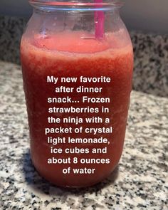 a drink in a mason jar with a straw on the top that says, my new favorite after dinner snack frozen strawberries in the nila with a packet of crystal light lemonade