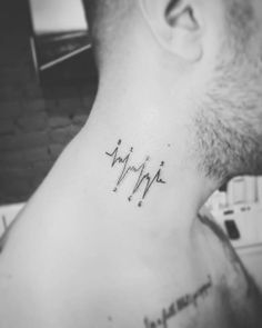 a man with a heartbeat tattoo on his neck