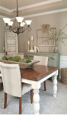 a dining room table with chairs and a bowl of food on it's centerpiece