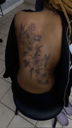 a woman's back with flowers on it