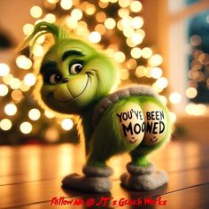 the grinch from the movie you've been mowed is standing in front of a christmas tree