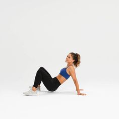 a woman is doing an exercise on her stomach