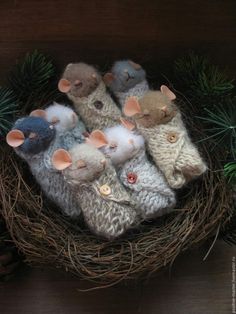 a group of knitted mice sitting in a nest