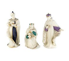 three ceramic figurines in the shape of kings and queen's robes,