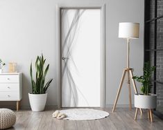 an open door in a white room with potted plants on the floor next to it