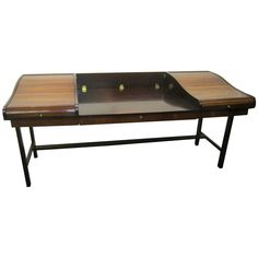 a wooden table with glass top and metal legs