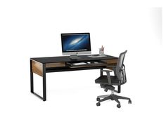 an office desk with a computer on top of it and a chair next to it