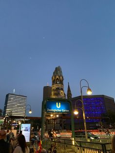 people are walking around in the city at night