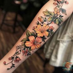 a woman's arm with flowers on it