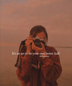 a woman taking a photo with her camera in front of the ocean and text that reads, it's an art to be your own better half