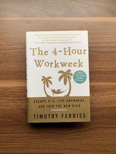 the 4 - hour work week book on a wooden table