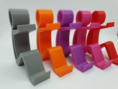 an assortment of colorful plastic objects on a white surface with one standing out from the others