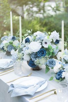 the table is set with blue and white flowers