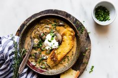 a bowl filled with soup and bread on top of a table