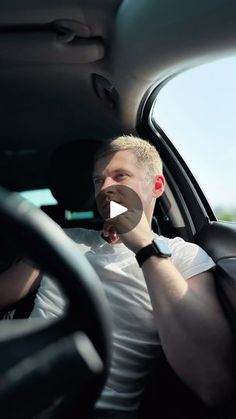 a man sitting in the driver's seat of a car