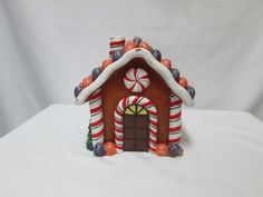 a gingerbread house with candy and candies on the roof is shown in front of a white background