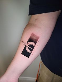 a person with a black and white tattoo on their arm