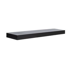 a black shelf sitting on top of a white wall