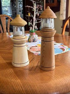 two wooden salt and pepper shakers sitting on top of a table