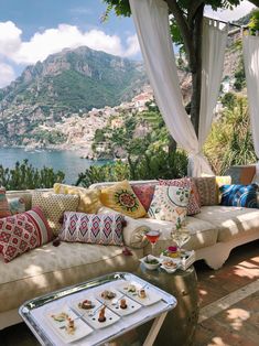 a living room filled with lots of pillows and furniture