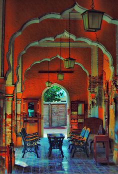 the inside of an old building with chairs and tables