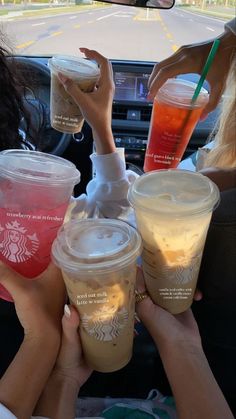 starbucks drinks are being served in the back seat of a car