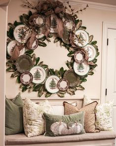 a bench with pillows and wreaths on the wall