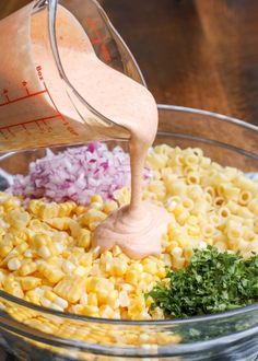 ingredients for macaroni and cheese being mixed in a bowl