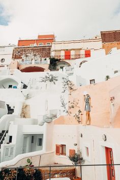 an image of a building that looks like it has been painted white and orange with red shutters