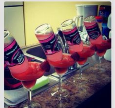 a group of glasses filled with liquid sitting on top of a counter